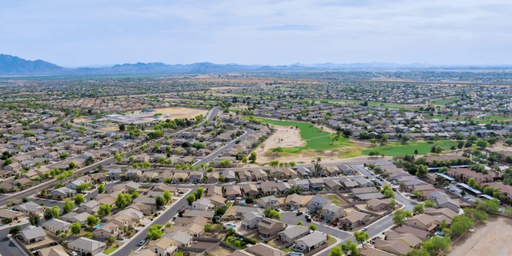 Aerial view of a sprawling suburban neighborhood with mountains in the distance.