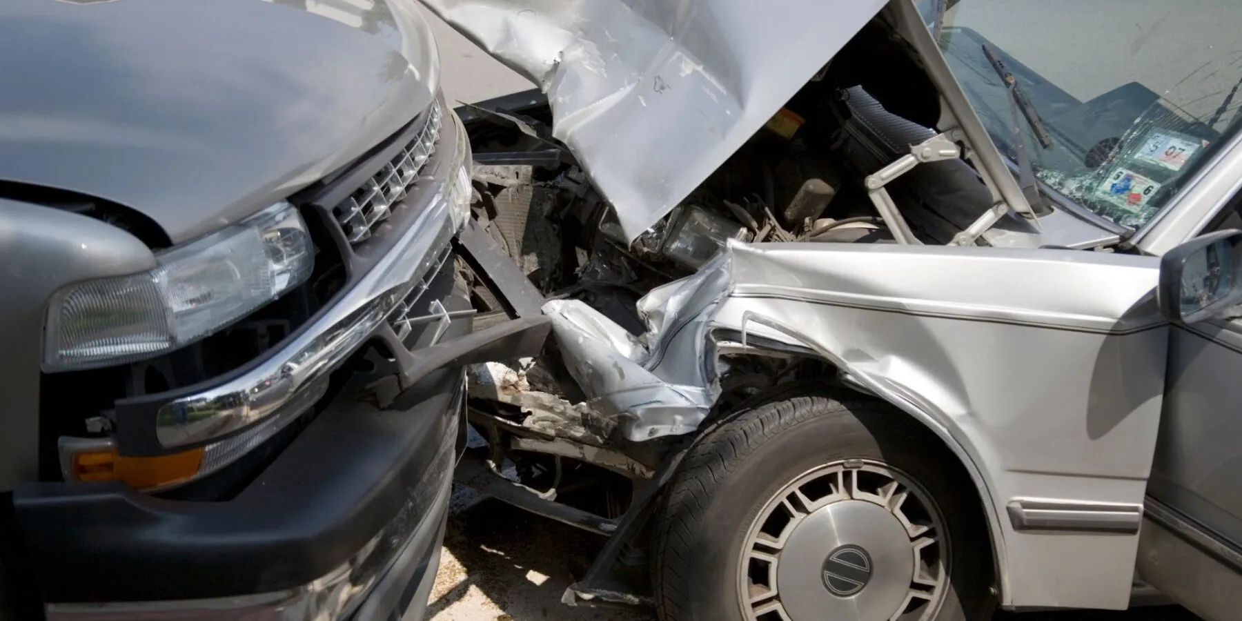 A severe head-on collision between two cars.