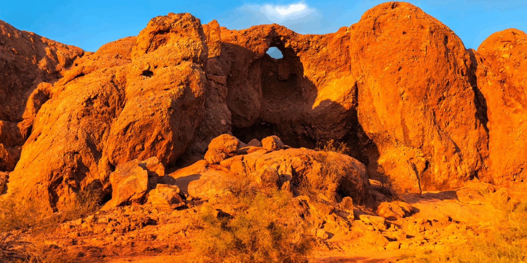 The "Hole-in-the-Rock" sandstone formation at Papago Park in Phoenix under a clear blue sky.